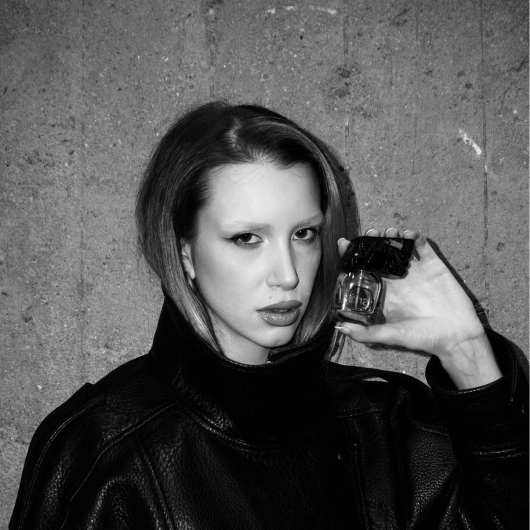 Girl in leather jacket with perfume